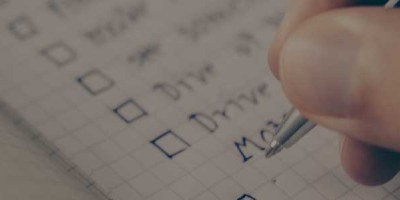 A checklist being written on paper